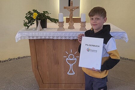 Elias Schnabl präsentiert das Pilgerbuch, das sich seit Anfang Mai in der Kapelle in Walterschlag befindet.