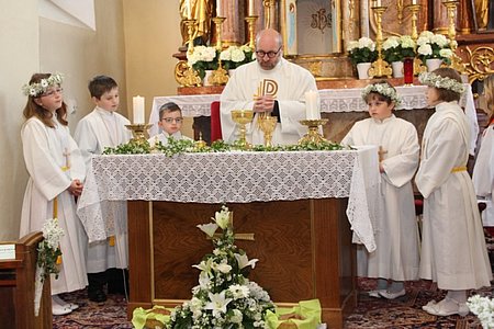 Pater Daniel umgeben von den fünf Erstkommunionkindern